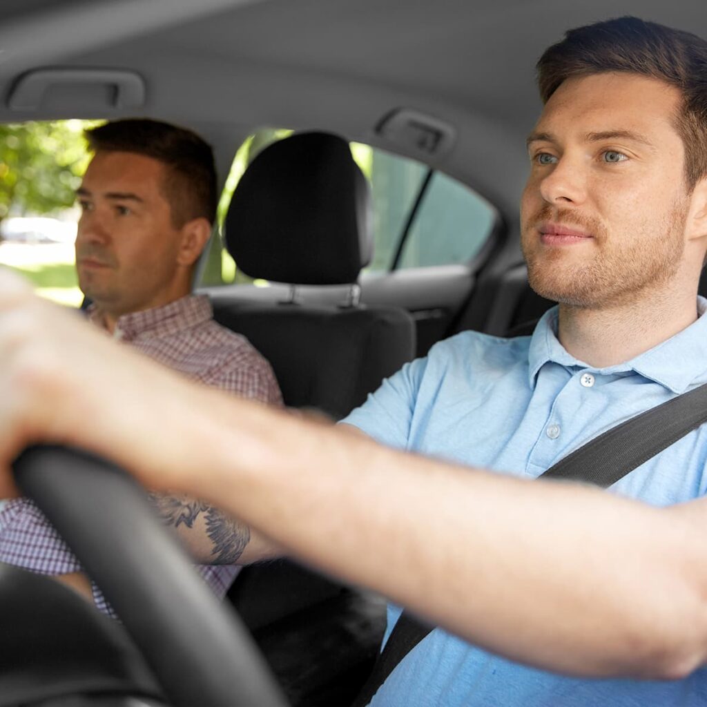 A man drives to work with a passenger.