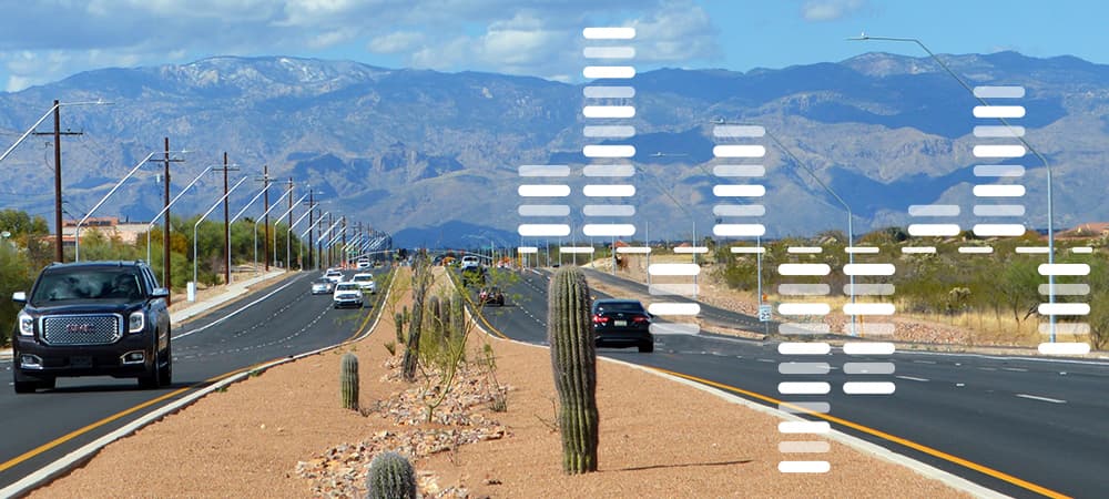 Cars drive on the freshly updated Houghton Road in Tucson, AZ.