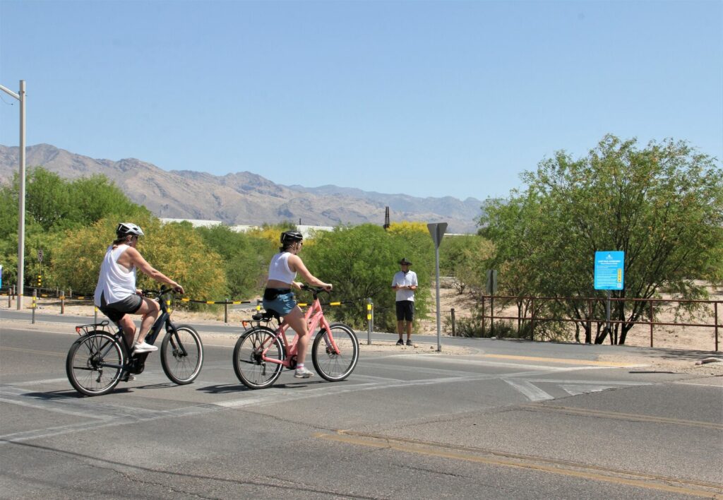 A volunteer takes count of 2 bicycle riders.