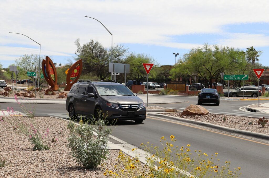A minivan exits a roundabout.