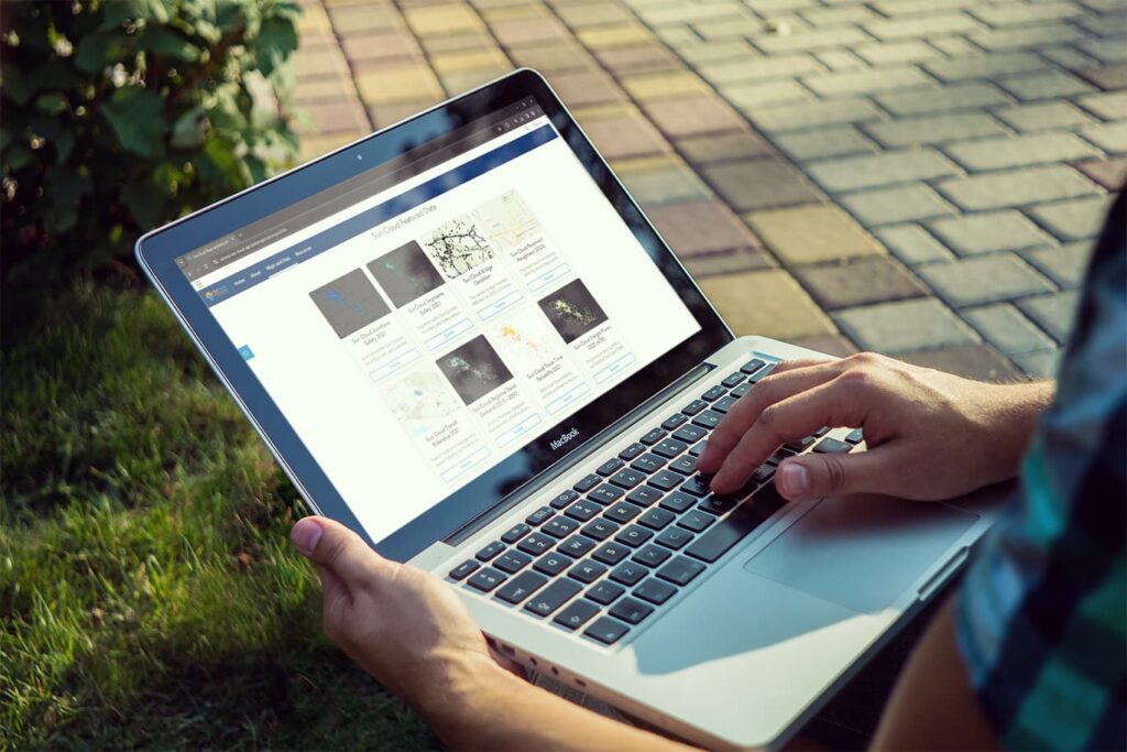 A man browses the Sun Cloud data portal on a laptop.