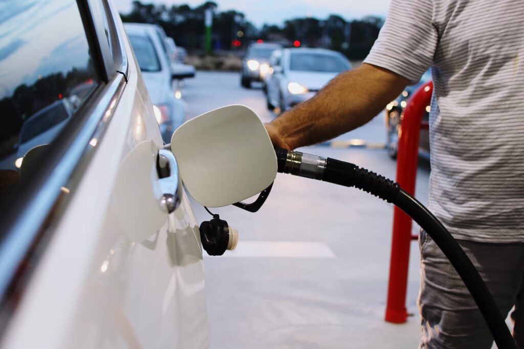 A man refuels his car after 6 p.m. when temperatures are cooler and ozone levels are lower.