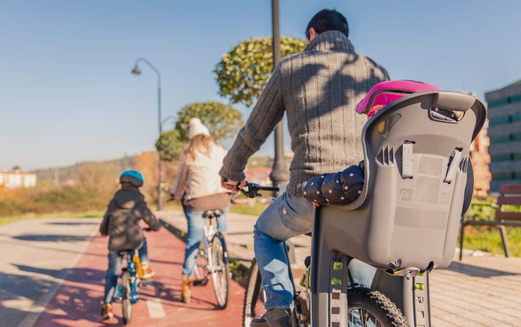 Family with children riding bicycles in the nature.