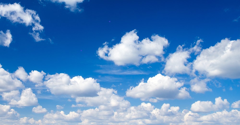 A bright blue sky with some clouds.