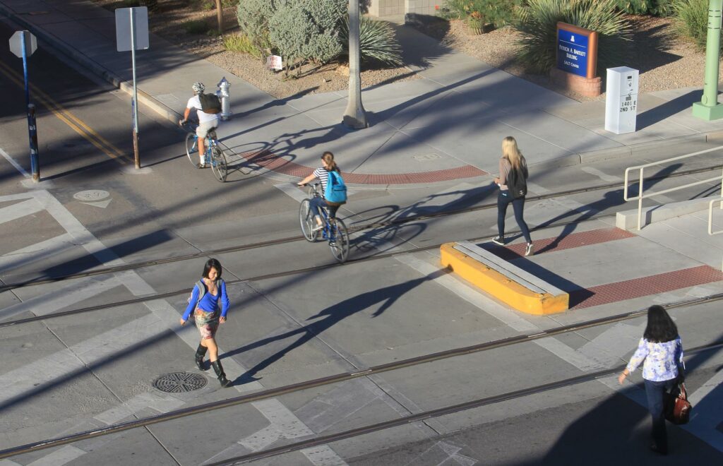 Pedestrians and cyclists use crosswalks.