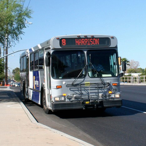 A bus pulls into a bus stop pullout.