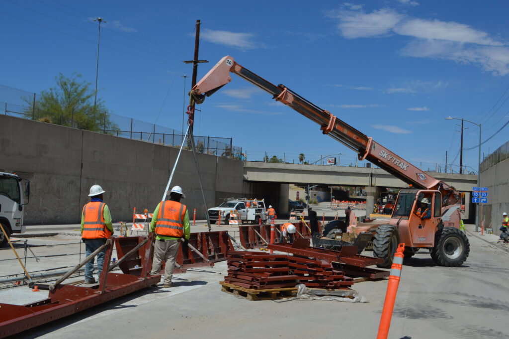Workers prepare barricades on the Grant Road UPRR project. 