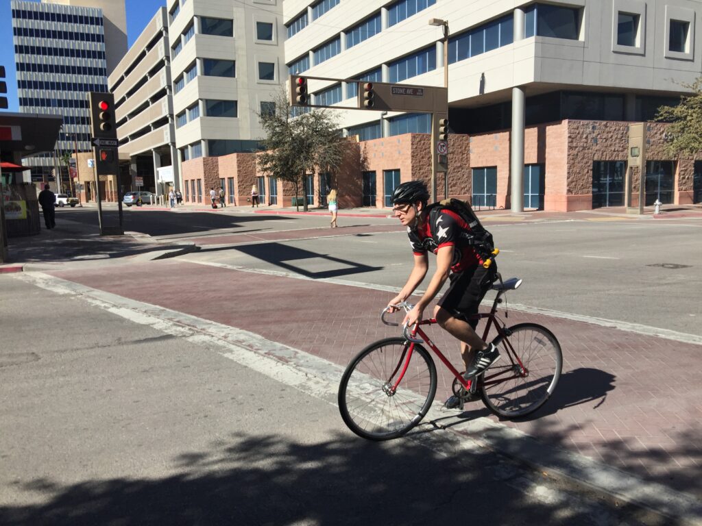 Bicyclist cycling on a street.