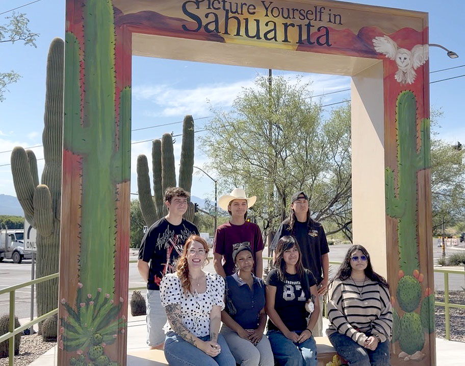 Student artists pose with their creation as part of the Sahuarita TABY project.